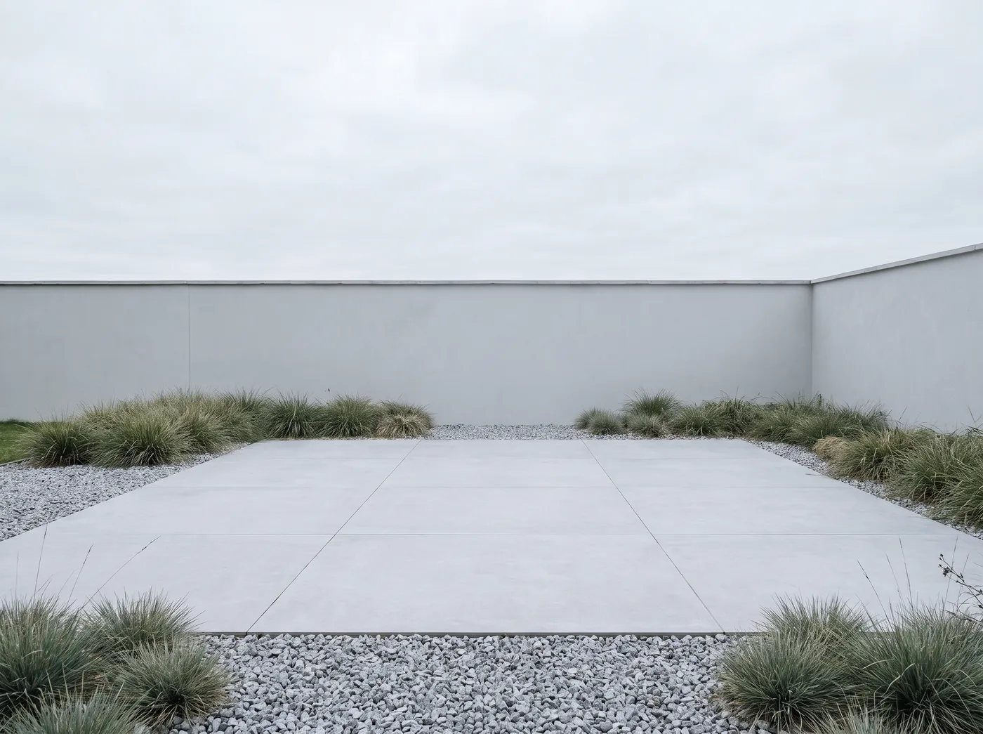 Contemporary garden patio in pale grey porcelain slabs with hairline joints